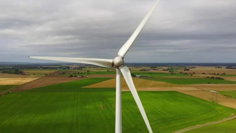 Aerial front view of a wind turbine in the wind, zooming out Stock Footage 283812735