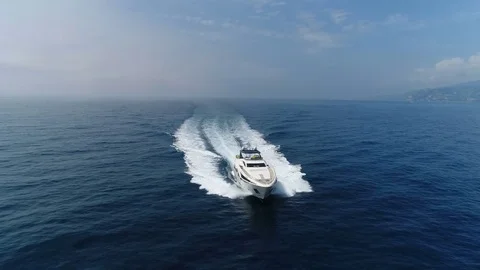 Aerial front view of a yacht navigating Stock Footage 76256207
