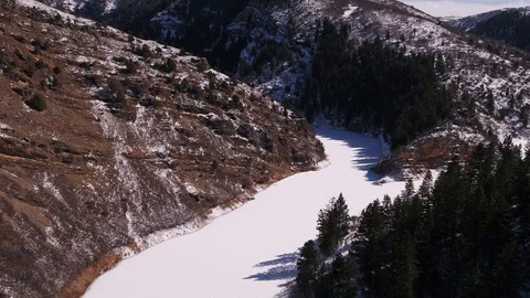 Aerial Frozen River Fork in Mountains Stock Footage
