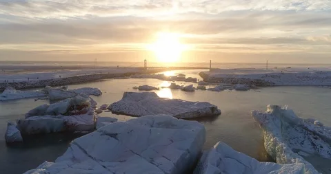 Aerial of glacier patterns and shapes in lake at sunset Stock Footage 116256586
