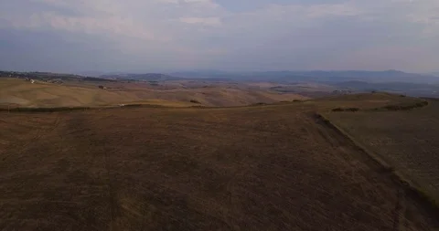 Aerial, gorgeous view on the road in the middle of plowed fields landscape in Video stock 101373552