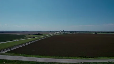 Aerial of grain elevators and farm land in rural Kansas Stock Footage 317814740