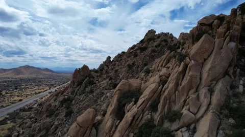 Aerial of granite slabs on a mountains side with an interstate highway below Stock Footage 171383133