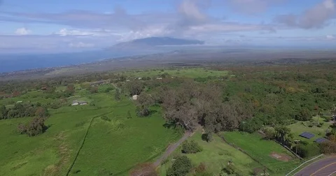 Aerial Green Mountain Flying Down Slope Towards Valley Island Stock Footage