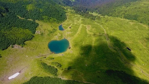 Aerial of a green valley with two tiny lakes in the Carpathians in summer 動画素材 93685585