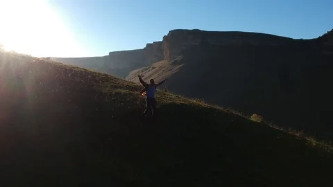 Aerial the guy coming down from the Mountain Ranges Stock Footage 97278190