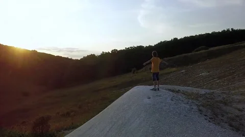 AERIAL:  guy standing on the mountain stretching his hands feel freedom and t Stock-Footage 79407274