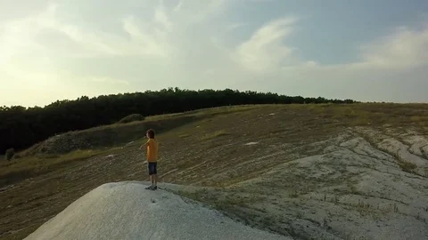 AERIAL:  guy standing on the mountain stretching his hands feel freedom and t Video stock 79407425