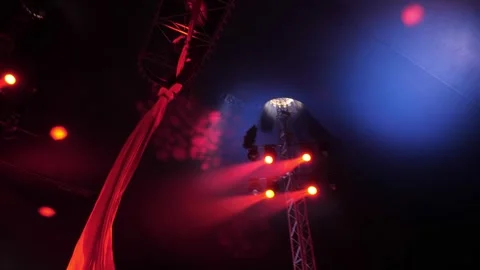 An aerial gymnast performs tricks on the fabric under the dome of the circus. Stock Footage 309085294