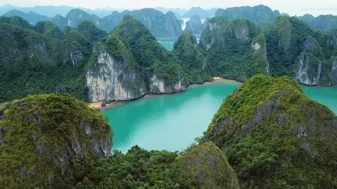 Aerial Halong Bay sharp rocks slopes blue sea Cruise ships Travel Vietnam UNESCO Stock Footage 106985336
