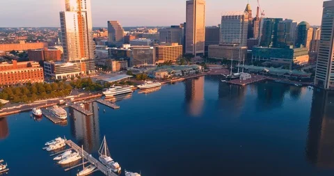 Aerial: Harbor and city skyline in Baltimore, Maryland at sunrise. Stock Footage