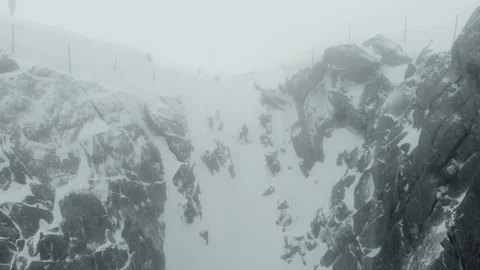 Aerial of heavy snow falling down from peaks of mountain in french alps Stock Footage 121595308