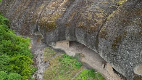 Aerial High Angle Fly Up and Out in Meteora, Greece Hermit Caves of Badovas.. Stock Footage 334898058