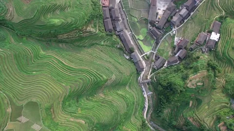 AERIAL HIGH ANGLE FLY OVER OF TIANTOUZHAI VILLAGE AND RICE TERRACES Stock Footage 65300903