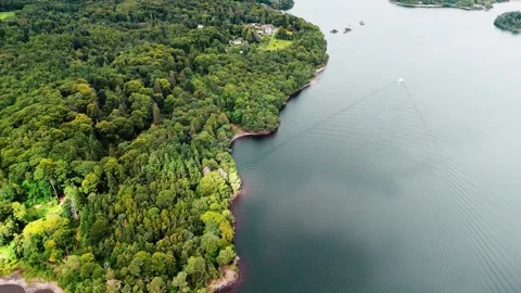 Aerial High Angle Panning Left Over Ullswater Lake with Forest in Summer Stock Footage 315710377
