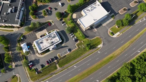 Aerial High-Angle Shot Moving Over Commercial Buildings Parking Lot and Street Stock Footage 346734058