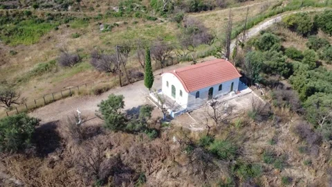 Aerial high angle shot of a traditional chapel surrounded by nature Stock Footage 344105239