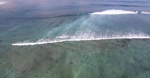 AERIAL high angle shots of ocean waves breaking towards beach Stock Footage 59868527
