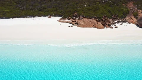 Aerial high angle of turquoise blue water, white sand, granite rocks, waves Stock Footage 125064873