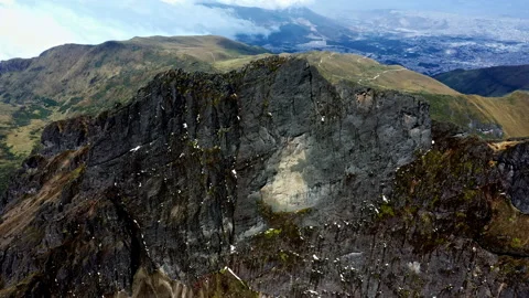 Aerial high angle view of a high rocky mountain top with leftover snow visible Stock Footage 234947424
