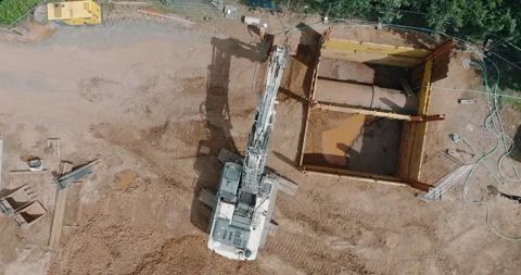 Aerial high angle view of hydraulic excavator at pipeline construction site pit Video stock 329565543