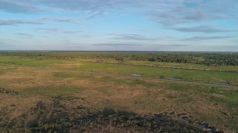 Aerial high angle view of an intercity road and railway between green fields in Stock Footage 209140260