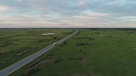 Aerial high angle view of an intercity road with traffic between green fields in Stock-Footage 209141134