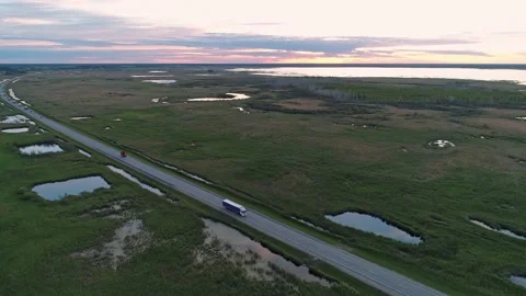 Aerial high angle view of an intercity road with traffic between green fields in Video stock 209141599