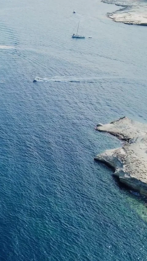 Aerial high angle view of a limestone headland separating two scenic bays f.. Stock Footage 327034625
