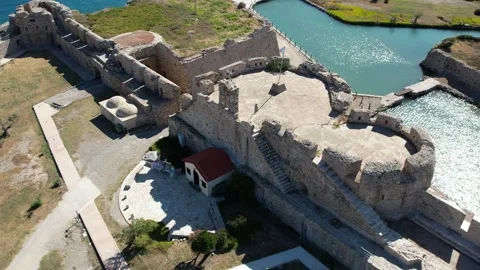 Aerial high angle view of medieval coastal castle and church Stock Footage 338103823