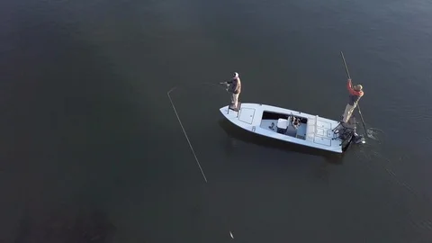 Aerial high angle view of men fly fishing from a small boat. Stock-Footage 121266912