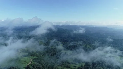 Aerial high angle view of mountain range covered in dense fog creating mist.. Vídeos de archivo 334319933