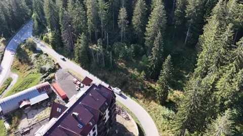 Aerial High Angle View of Mountain Hotel Resort and Car Driving on Curved Road 動画素材 343943721