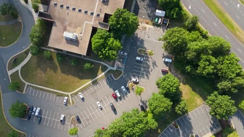 Aerial High-Angle View Moving Over Commercial Building Parking Lot Stock Footage 346734113