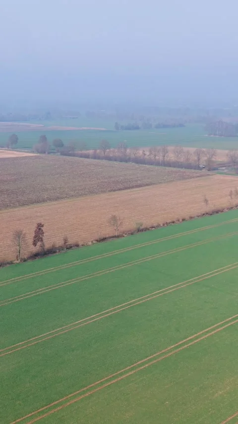 An aerial high angle view shows vast agricultural fields and farmlands Video stock 335727967