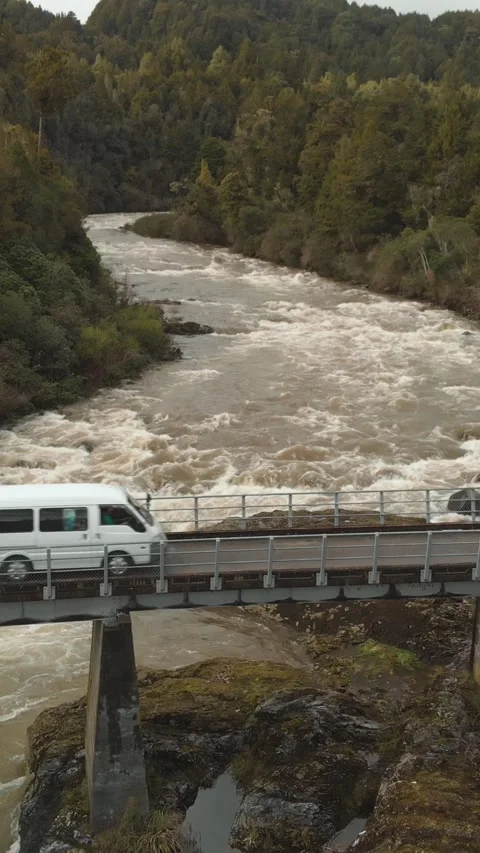 Aerial high angle view of small camper van driving through a mighty river a.. Stock Footage 288503817