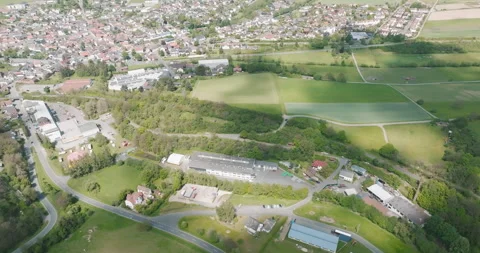 Aerial high angle view of small town residential area next to green fields Stockbeeldmateriaal 329558106