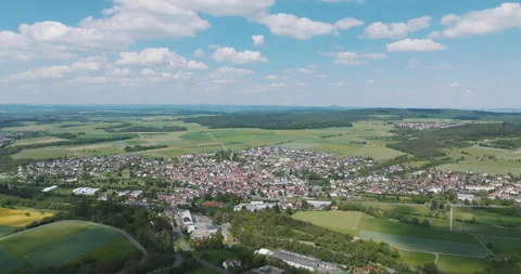 Aerial high angle view of small town residential area next to green fields Stockbeeldmateriaal 329558616