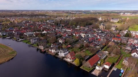 Aerial high angle view of a traditional Dutch town with red roofed houses Video stock 334628247