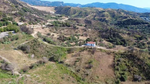 Aerial high angle wide angle view of a secluded mountain chapel Stock Footage 344105272