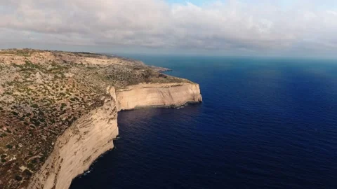 Aerial high angle wide landscape drone shot of the golden dingli cliffs at Stock Footage 336431823
