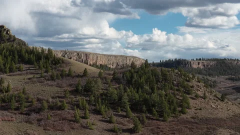 Aerial high desert cliffs and snow capped mountain peaks in Colorado springtime 스톡 동영상 332519164
