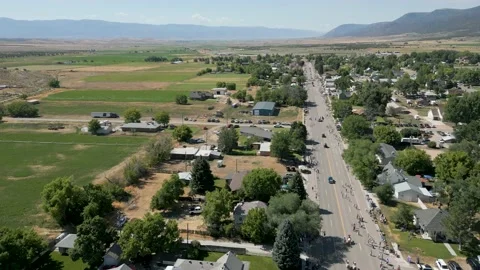 Aerial- High distant view of small town parade route. Video stock 202656802
