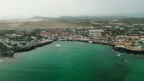Aerial high level panning view of Corralejo town, beaches and harbor Stock Footage 224037286