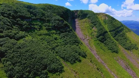Aerial of a high mountain with two thin gorges on its slope in the Carpathians Stock Footage 93509809