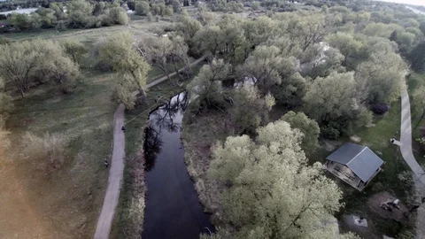 Aerial high over river running through park Stock Footage 92335649