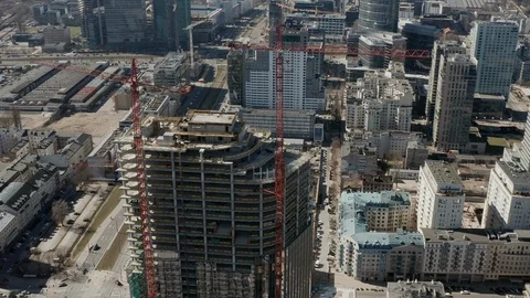 Aerial - High skyscraper construction site with 2 high cranes, Warsaw, Poland Stock Footage 105173085