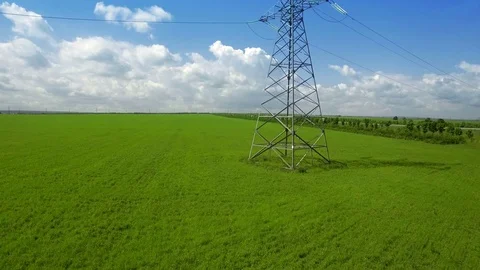 AERIAL High-voltage tower summer light sky background green grass up lift fly Stock Footage 78675255