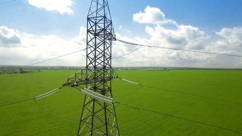 AERIAL High-voltage tower summer blue sky background green grass panorama fly Video stock 78676031