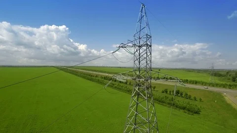 AERIAL High-voltage tower summer blue sky background green grass panorama fly Stock Footage 78676882